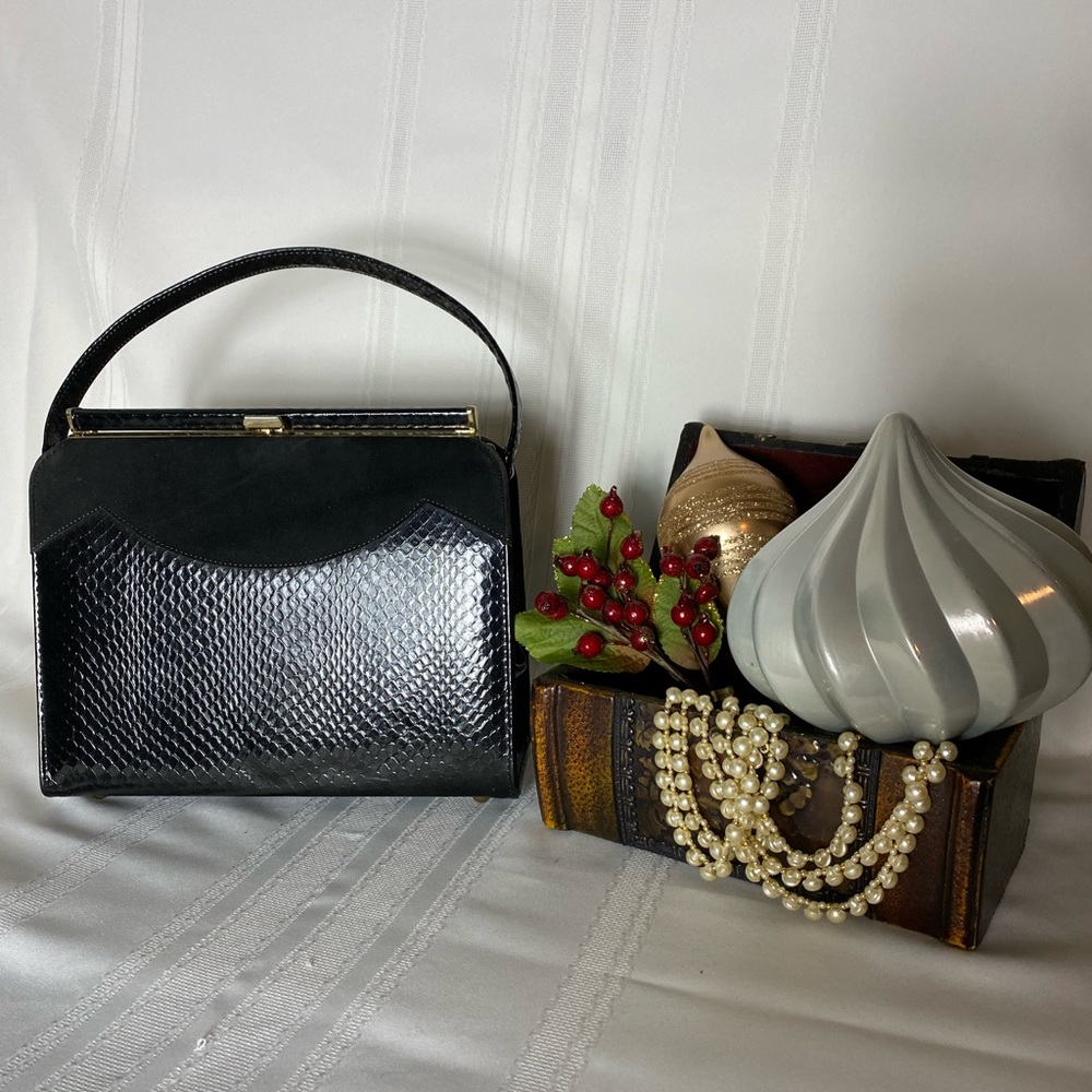Black vintage handbag with suede on front. Gold trim, closure and feet